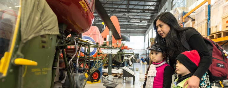 Family learning about military equipment