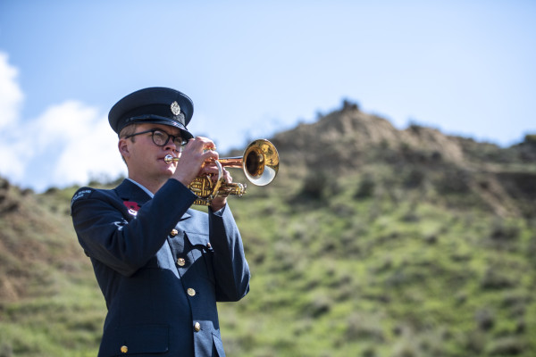 A man in Air Force uniform playing a bugle
