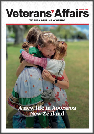 Front cover of VA Magazine showing women hugging two children in the grass