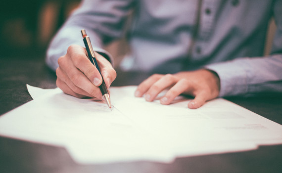 Close up of signing a document