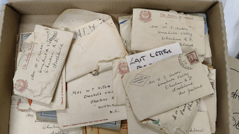 A cardboard box full of old letters.